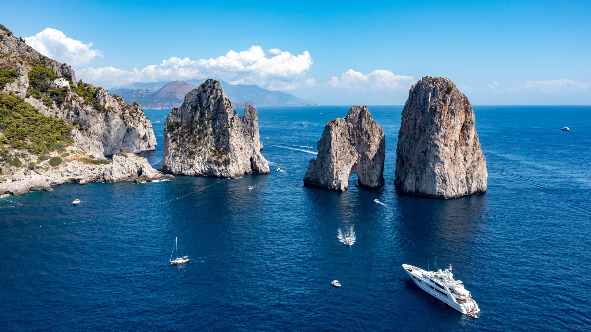 A superyacht anchored near the Faraglioni rocks in Capri