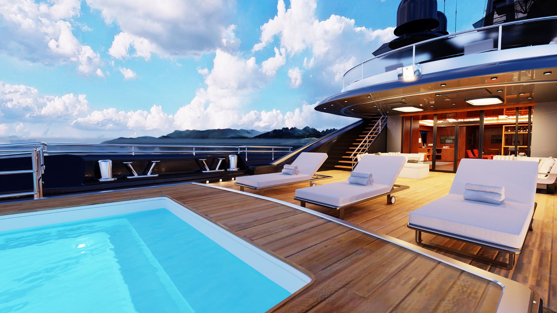 Sun deck of a superyacht at dusk with a pool, sun loungers and warm evening light across the water